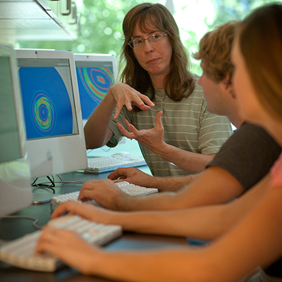 A Washburn biology professor works with students in Stoffer Science Hall