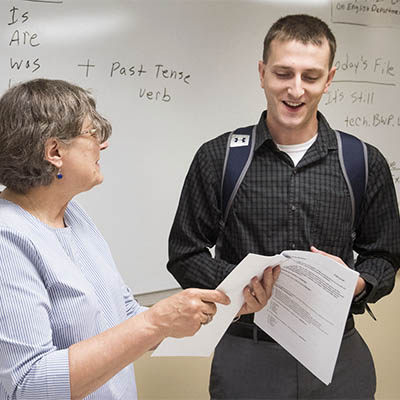 A student and professor chat after class