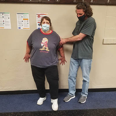 WU Moves client, left, works with trainer, right, on balance exercise against the wall.