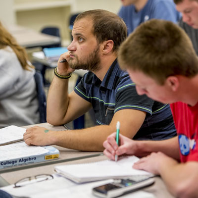 Students take notes while in a actuarial science class