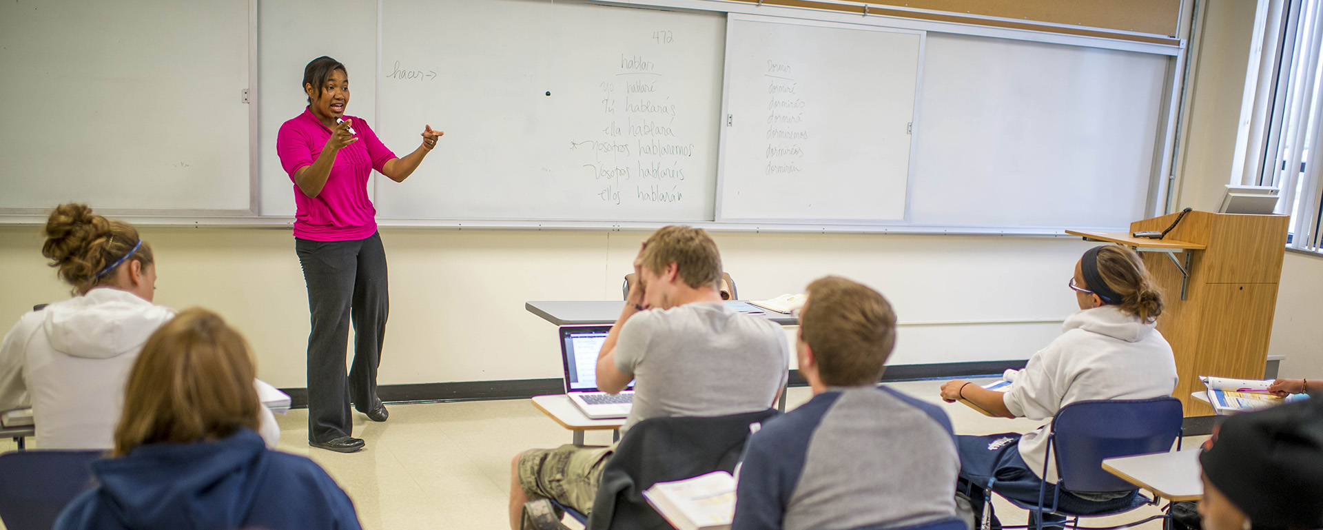 A Spanish professor teaches at the white board