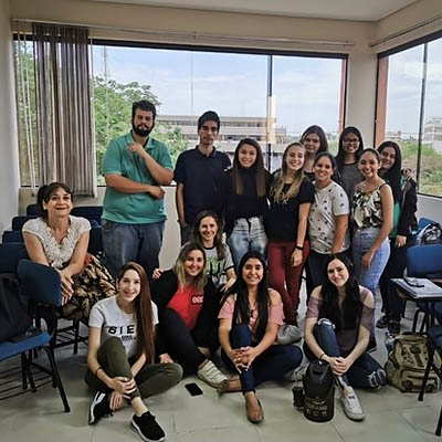 A group of about 15 students smile and pose for a photo in Paraguay.