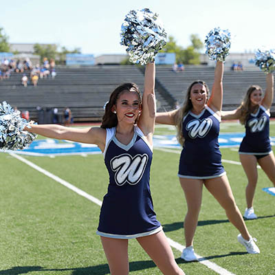 A dancing blue member smiles while performing