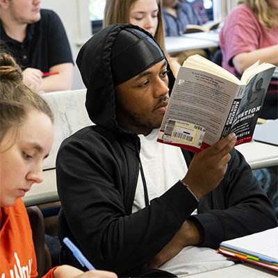 A student reads a book during a religious studies book