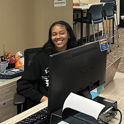student at front desk of intersection room