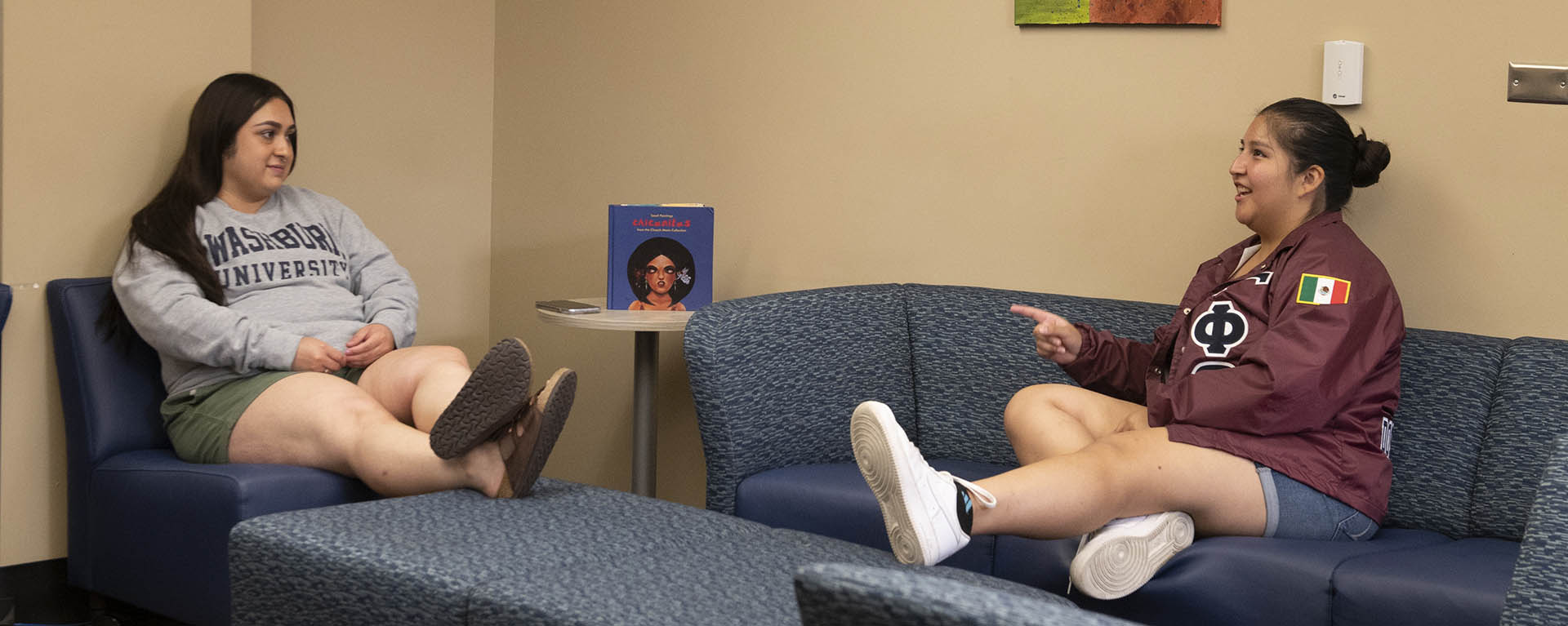 Two students talk in the multicultural intersectional learning space