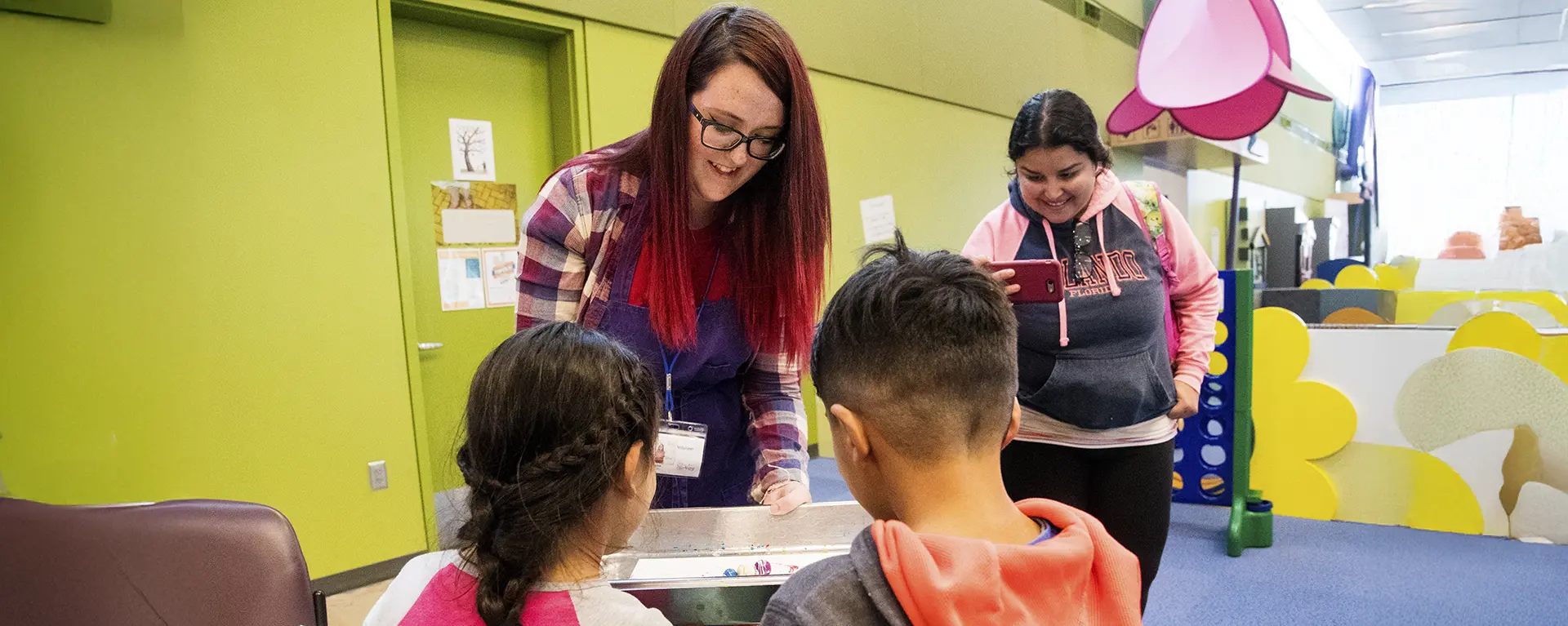 A WTE student works with kids at the Kansas Children's Discovery museum.