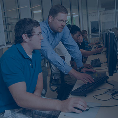 faculty and students working on computers