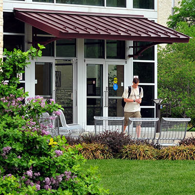 Memorial Union entrance with student walking out