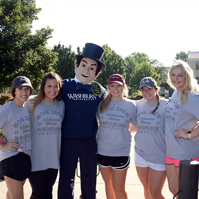 students standing with Ichabod mascot outside