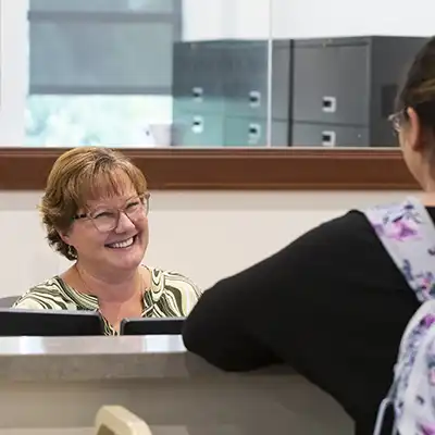 staff answering phone behind desk