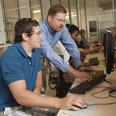 Professor and student at computer