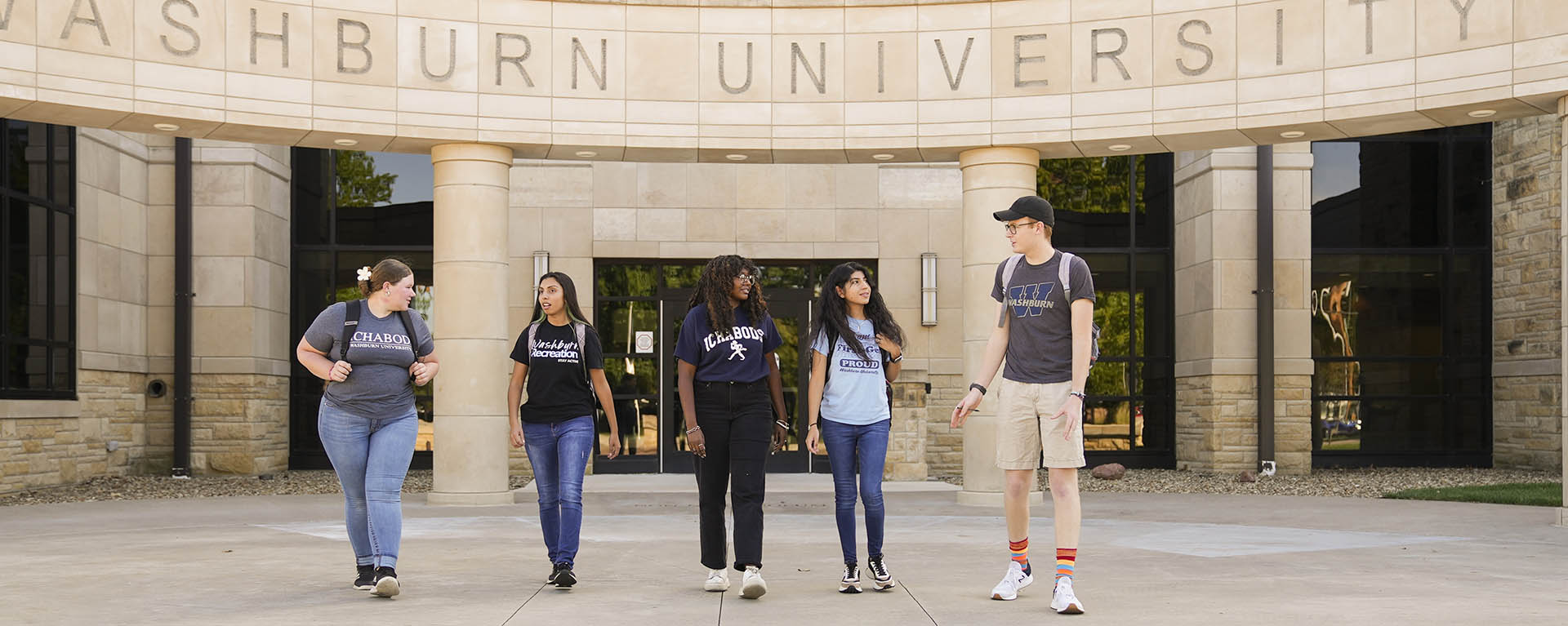 Washburn students chatting while outside Morgan Hall.