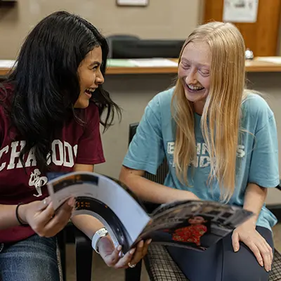 Students flip through the business magazine.