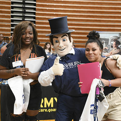 two students with Ichabod mascot at career fair
