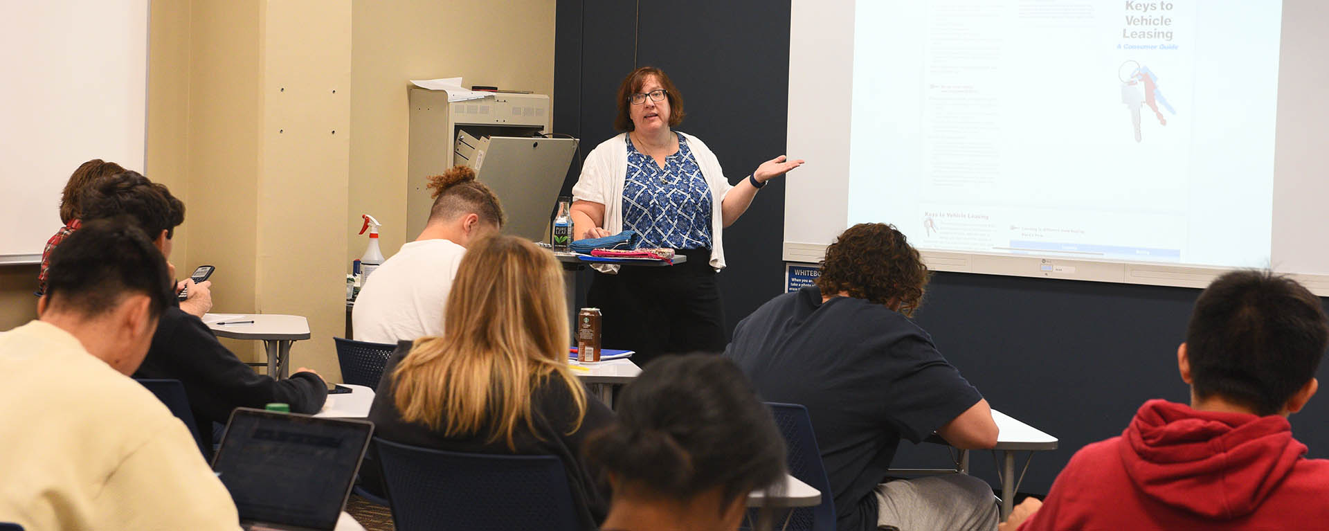 A math professor explaining a math concept at the board.