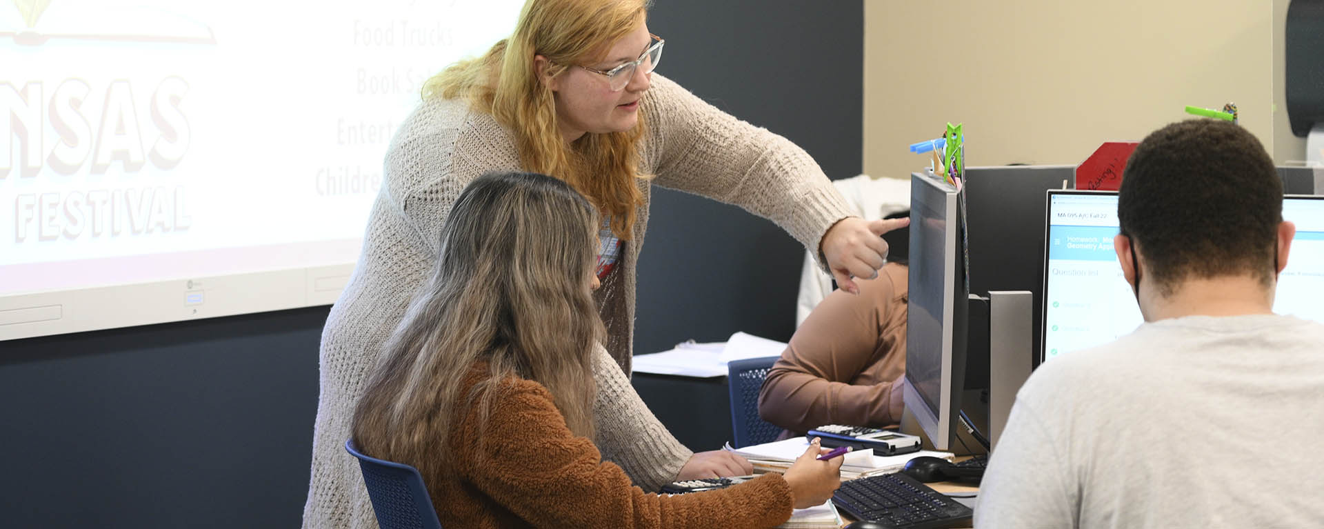 A student helps another student in the math lab at Washburn.