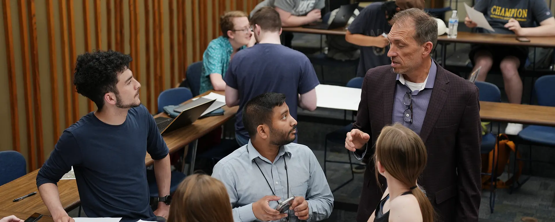 Political Science faculty talks with a group of students during class.