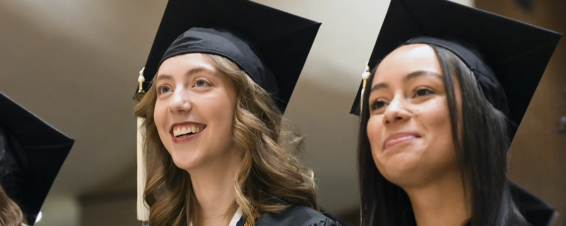 student smiles during commencement ceremony
