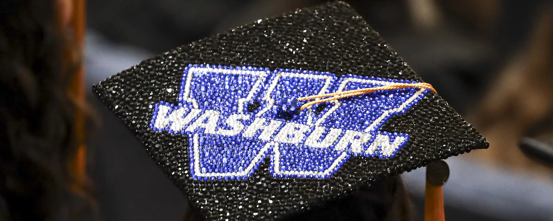 Graduation cap with Washburn logo.