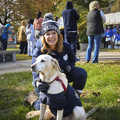 A Washburn employee with their dog at a football game.