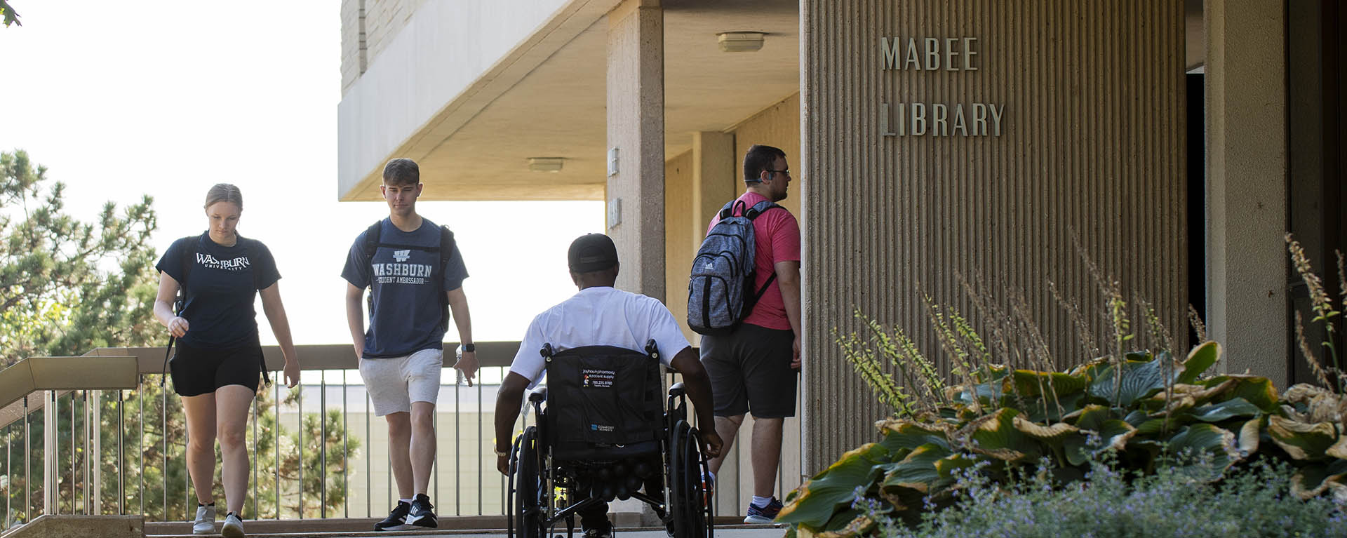 A wheelchair user travels across campus.