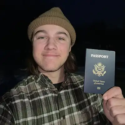 student holding passport