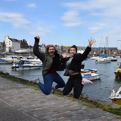 two students jumping in place in Scotland
