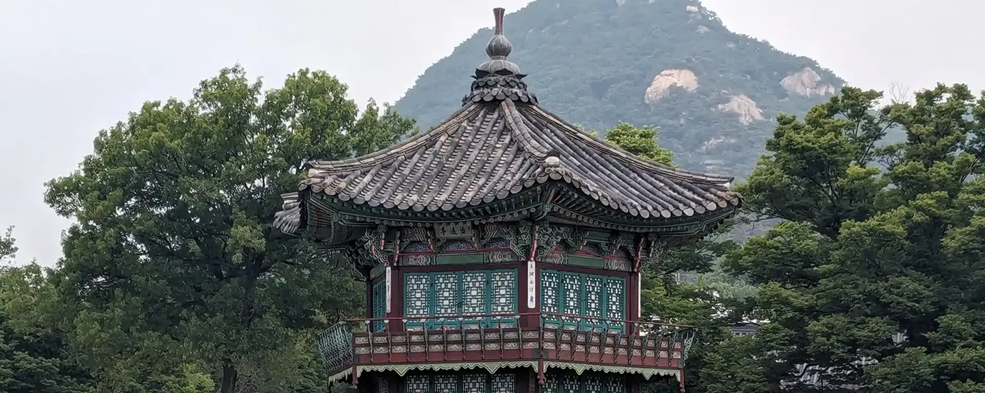 Korean temple rooftop with mountain behind