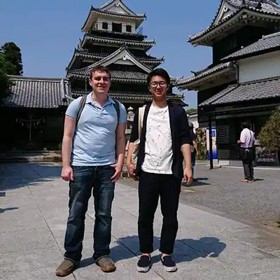 two students in front of Asian temple