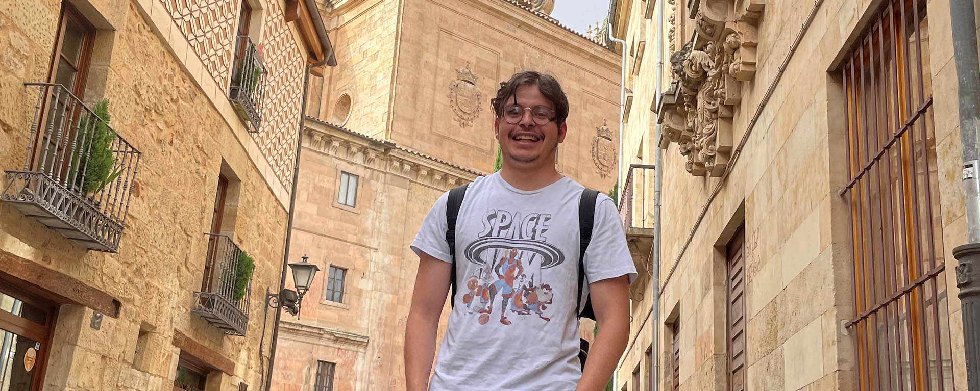 student in front of old city building