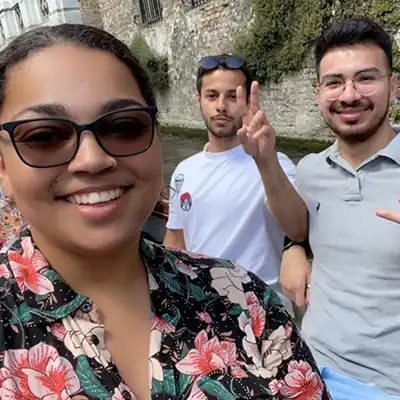 three students touring Belgium smiling
