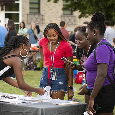 students at WUFEST event signing up at organizations table