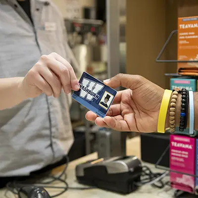 A student uses their iCard at a check out.