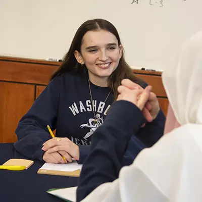 A student worker tutors another student.