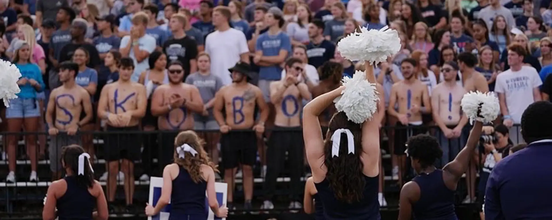 Cheerleaders pump up the Washburn crowd at a football game.