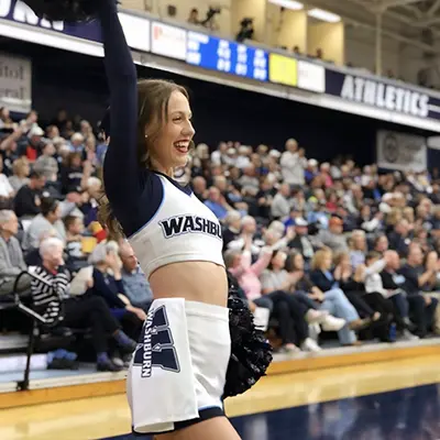 A cheerleader smiles while performing.