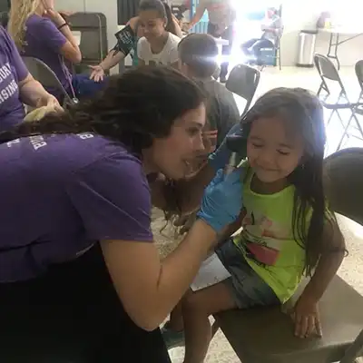 student nurse in Costa Rica examining young local