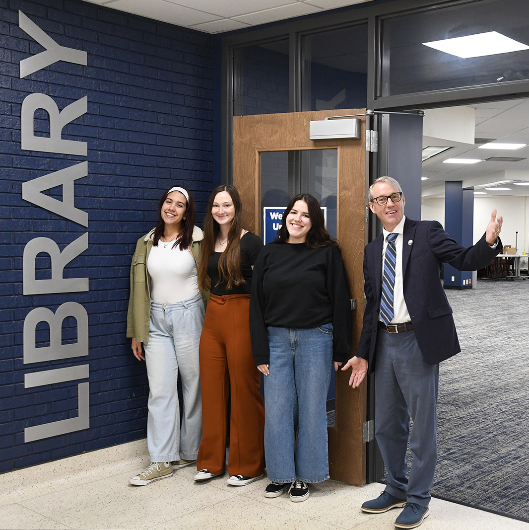 Librarian and Student Workers Standing in New Library Doorway